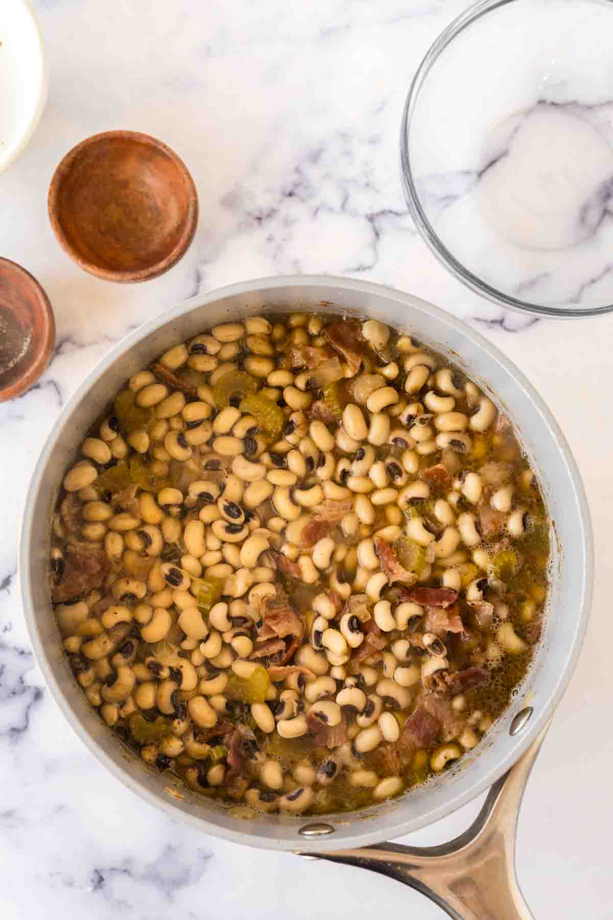 sauce pot with ingredients of black eyed peas