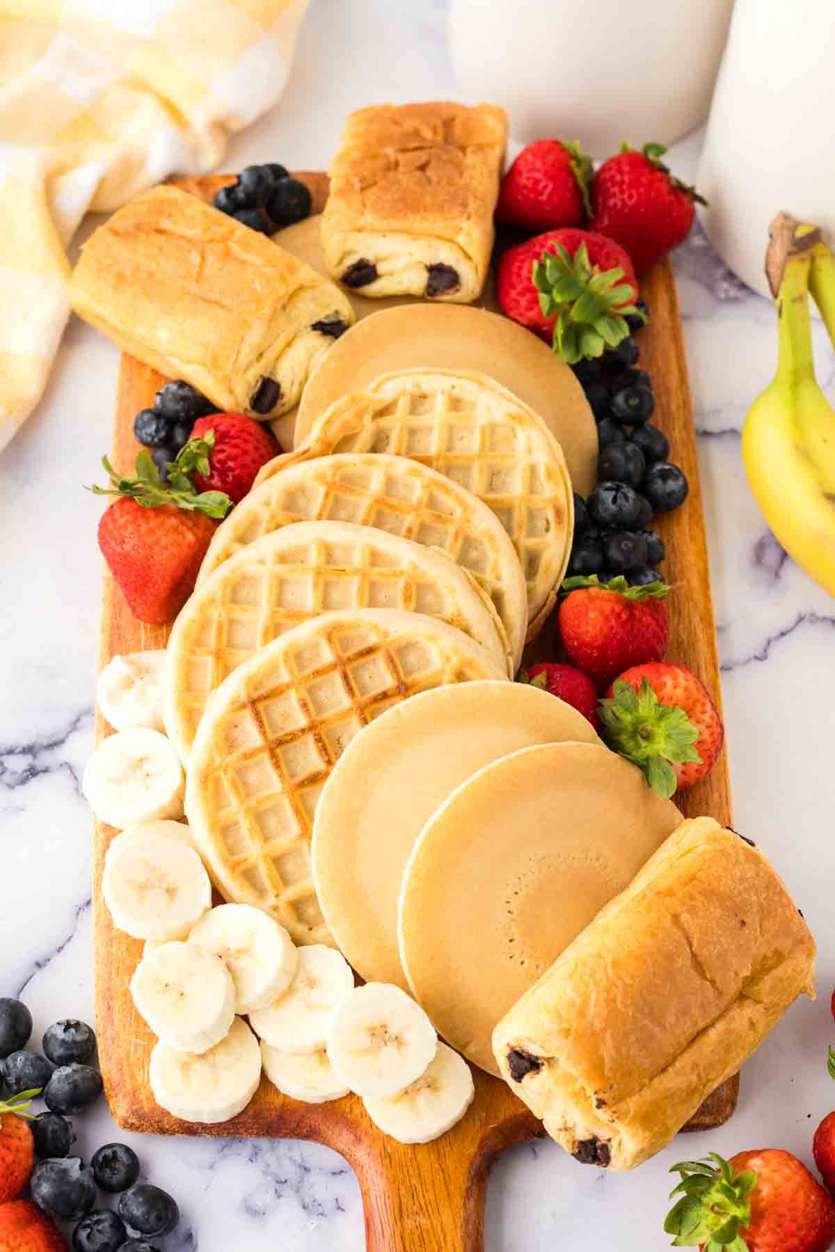 Spread of various breakfast items to form a breakfast charcuterie board.