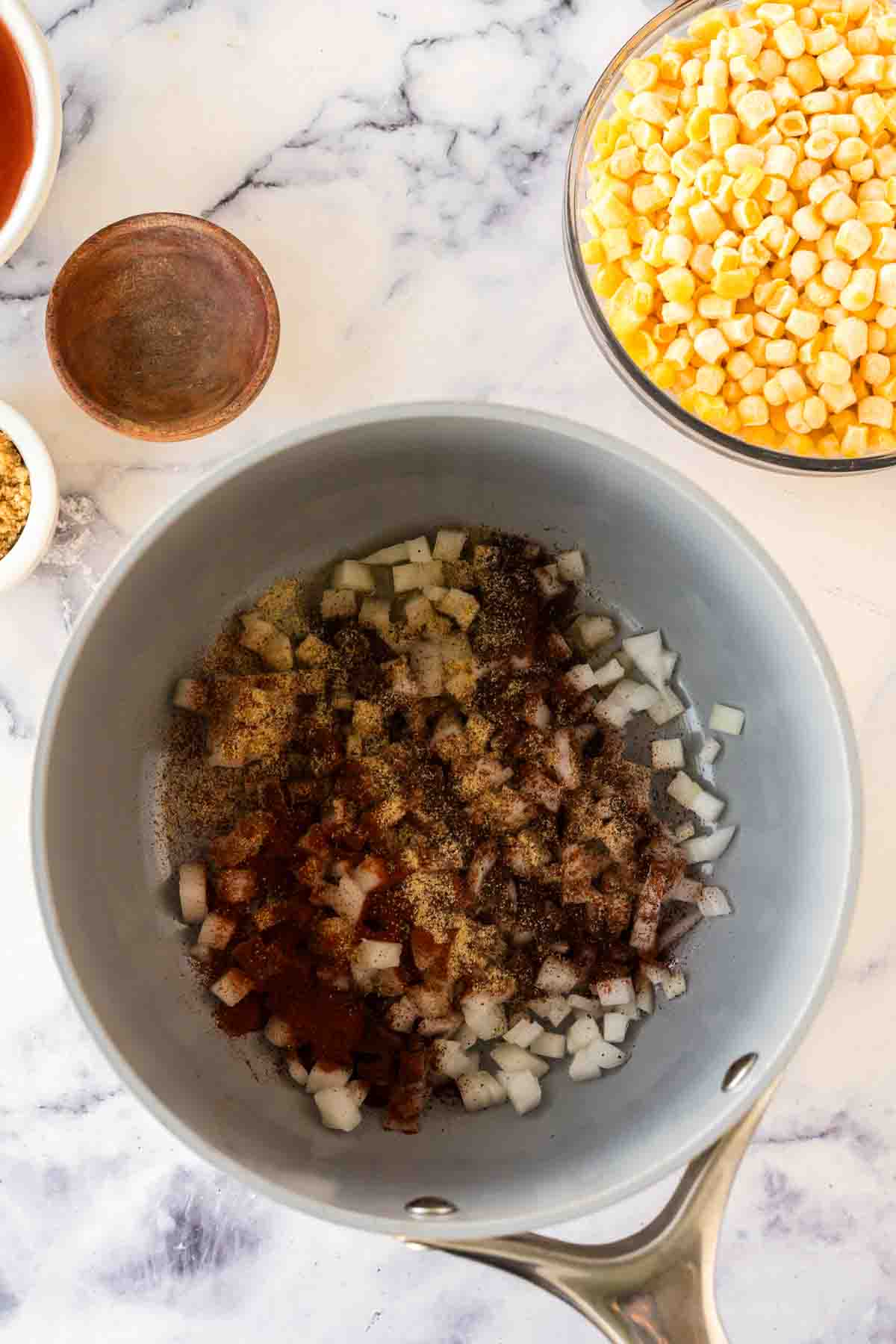 Sautéing ingredients for brunswick stew in a large pot.