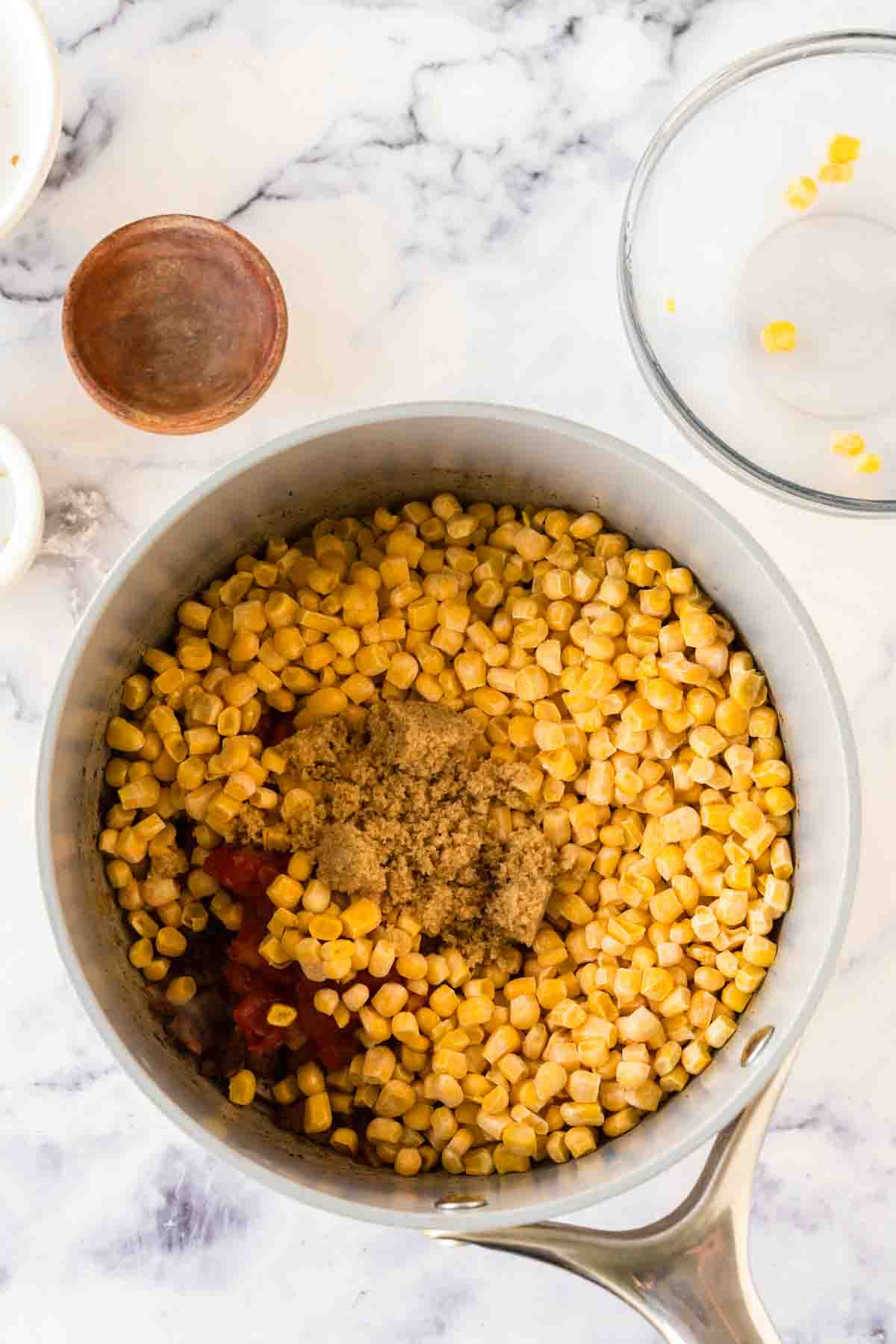Corn added to the pot of brunswick stew.
