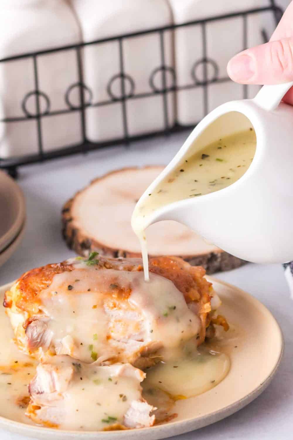 Chicken gravy being poured onto meat. 