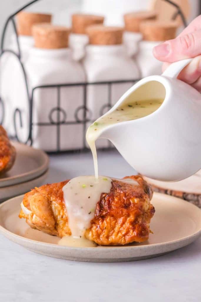 a white porcelin craft with chicken gravy being poured over