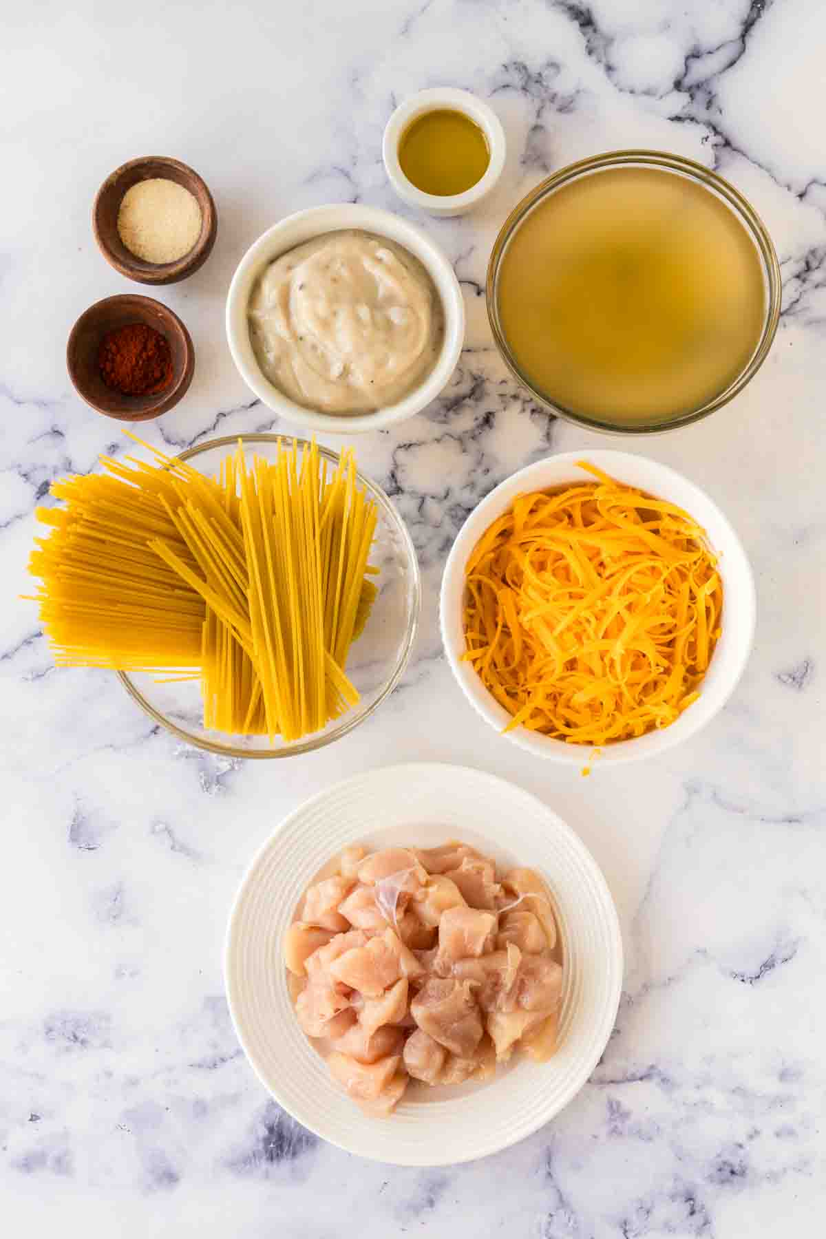 top view of portion dishes of raw ingredients for chicken spaghetti