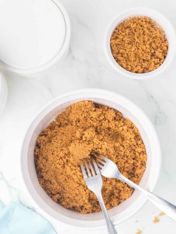 small white dish with softened brown sugar with forks in it