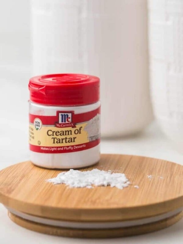 small jar of McCormick cream of tartar with a red lid.