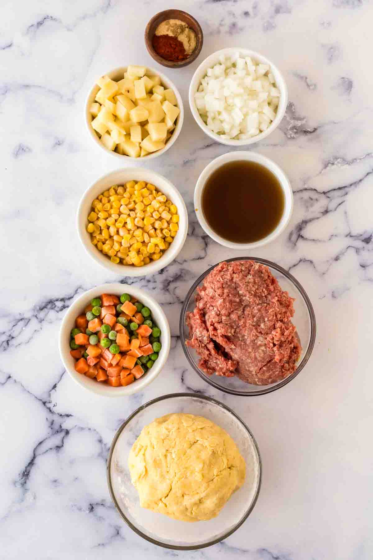 small portion dishes with raw ingredients for the empanada recipe