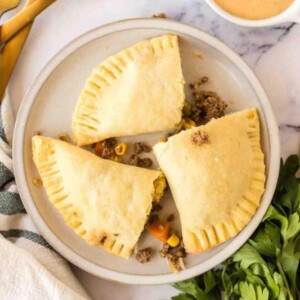 top view of cooked empanadas on a round plate