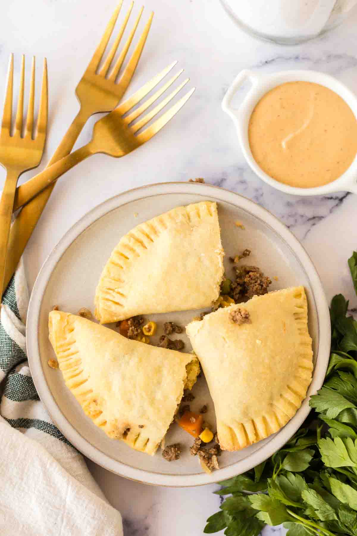 top view of cooked empanadas on a round plate