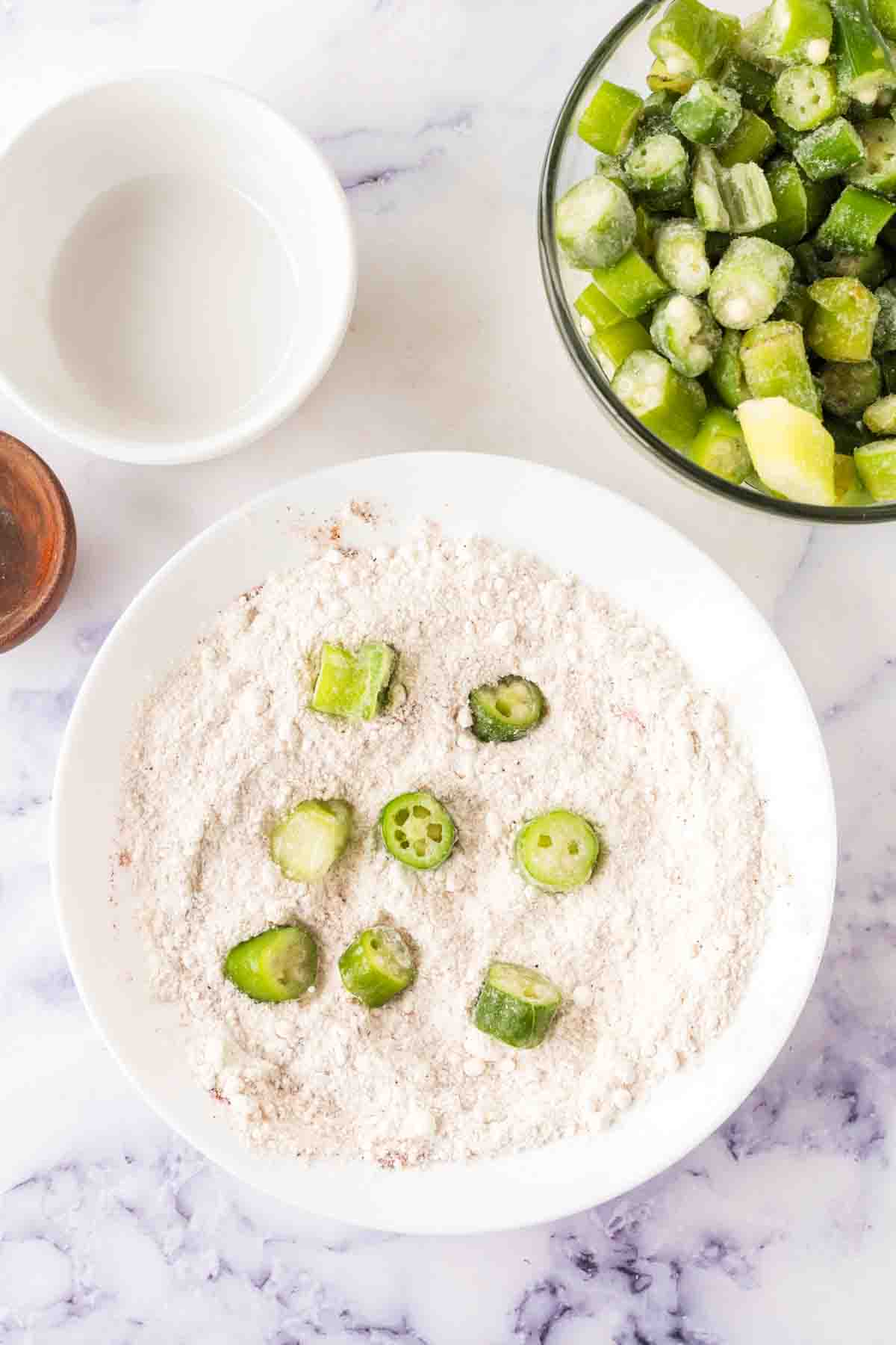 okra slices in a bowl of breading for fried okra recipe