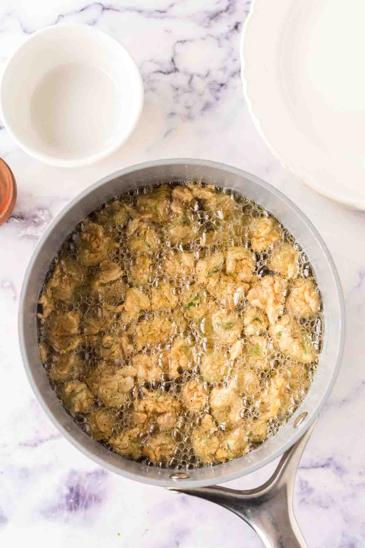 pot with bubbling oil and fried okra