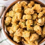 small wooden bowl with bits of fried okra stacked in