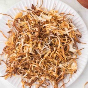 white plate with shreds of fried onions