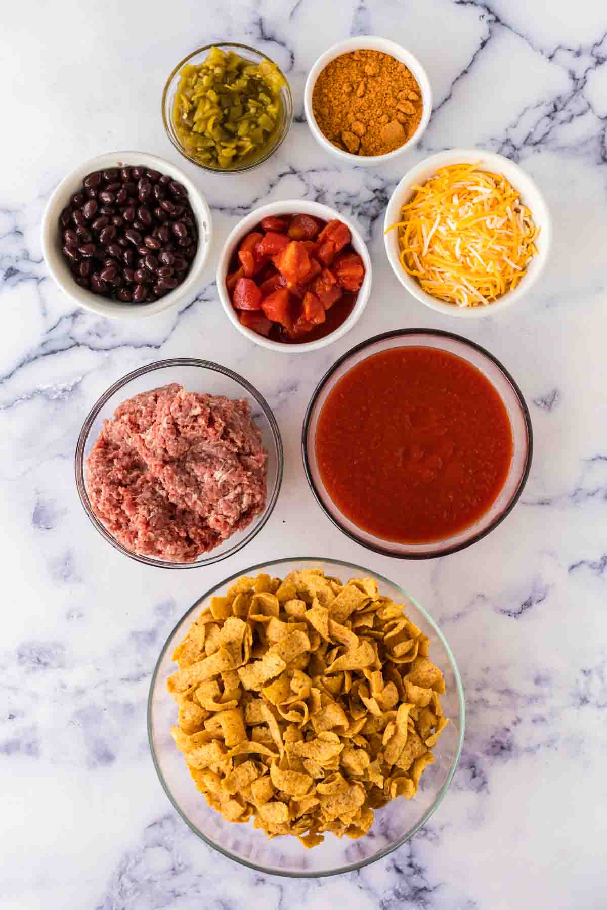 small portion dishes of ingredients for frito pie