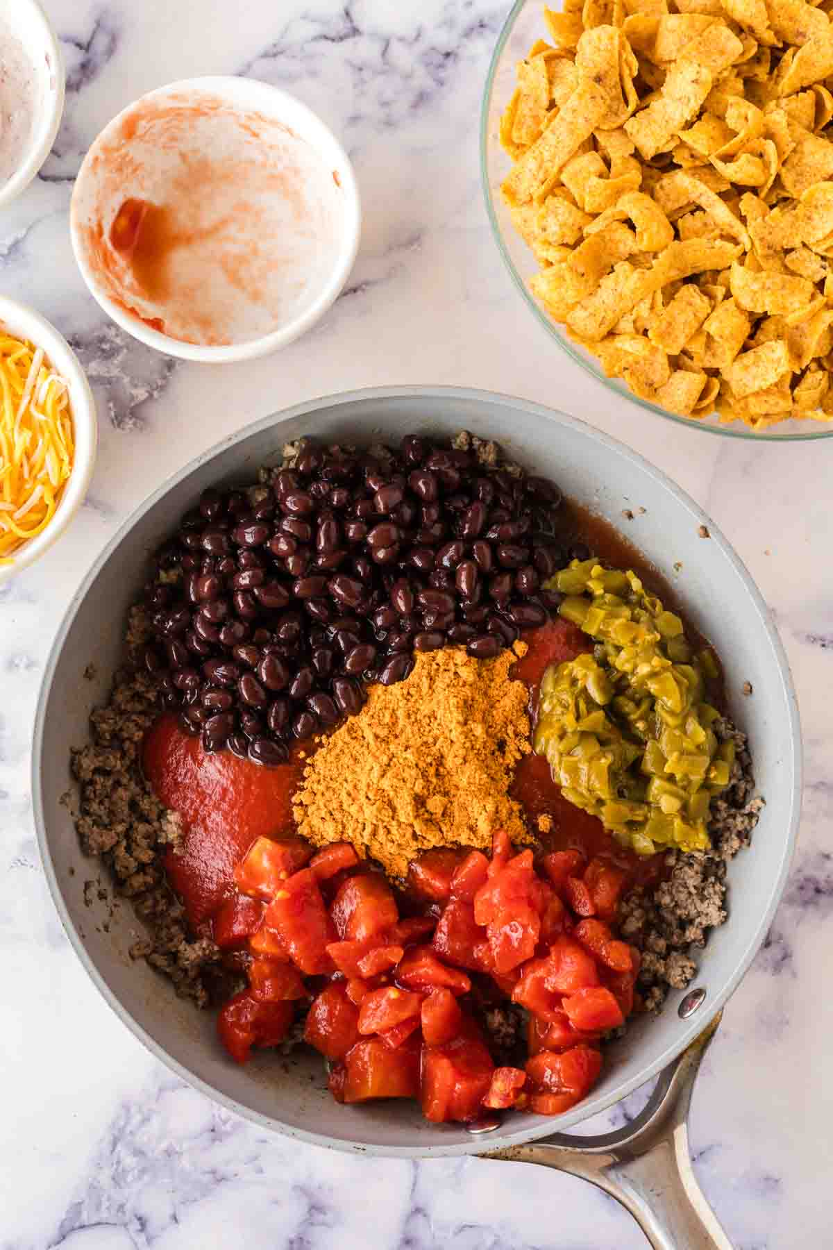 sautéed pan with ingredients for frito pie