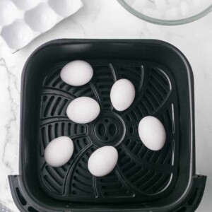 air fryer basket with whole eggs inside