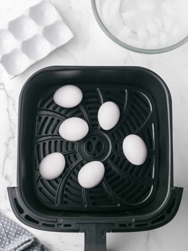 air fryer basket with whole eggs inside