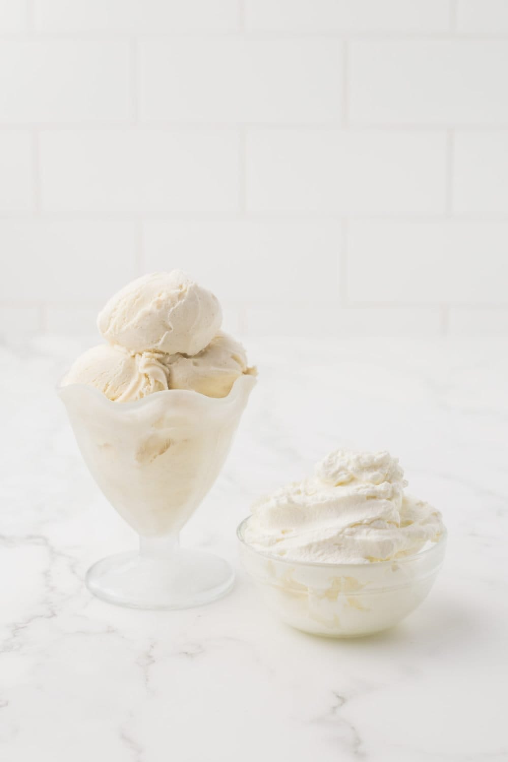 clear glass containers of piled whipped cream
