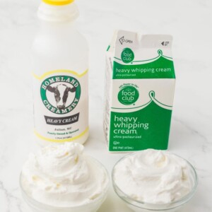 image of different containers of cream and heavy whipping cream next to two small clear bowls with cream