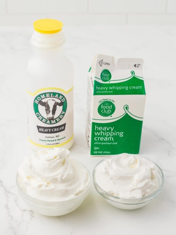 image of different containers of cream and heavy whipping cream next to two small clear bowls with cream