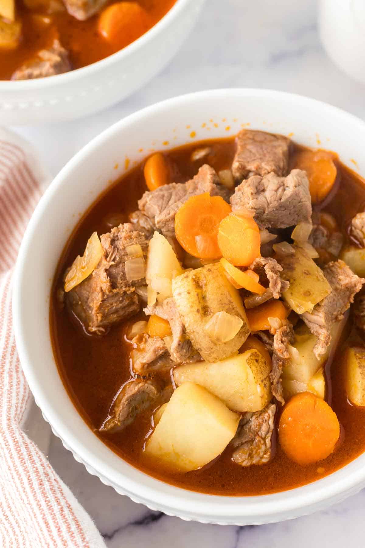 top view of a serving of Hungarian goulash in white bowls