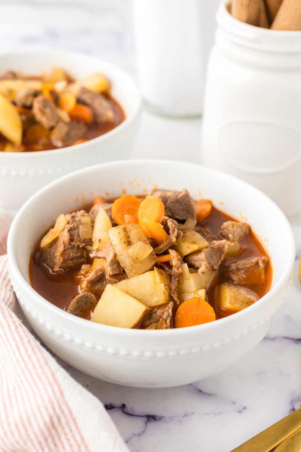 a serving of Hungarian goulash in white bowls