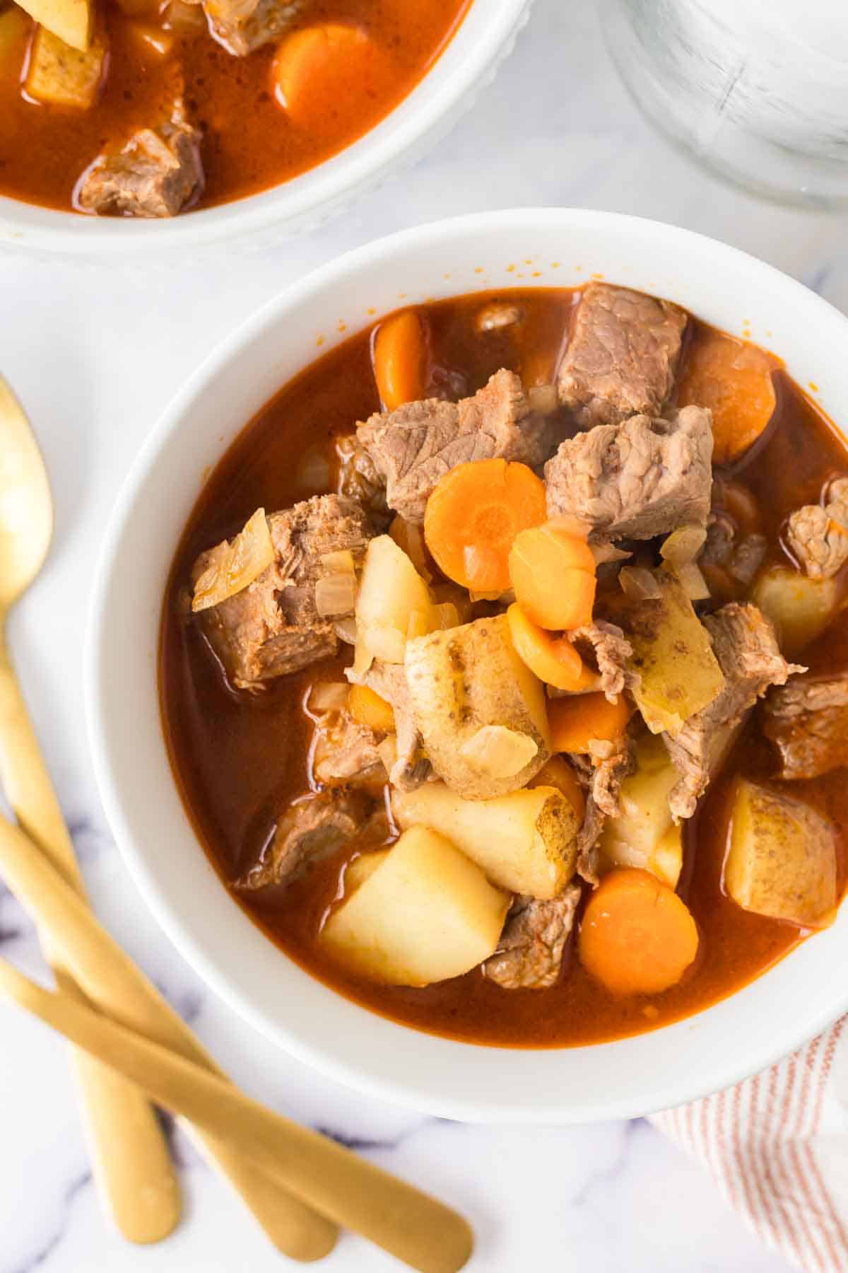 top view of a serving of Hungarian goulash in white bowls