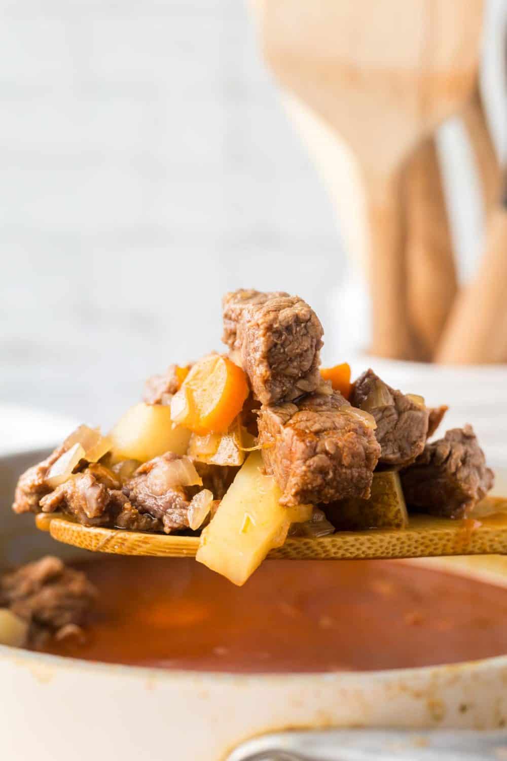 POV side view with a wooden soup of Hungarian goulash