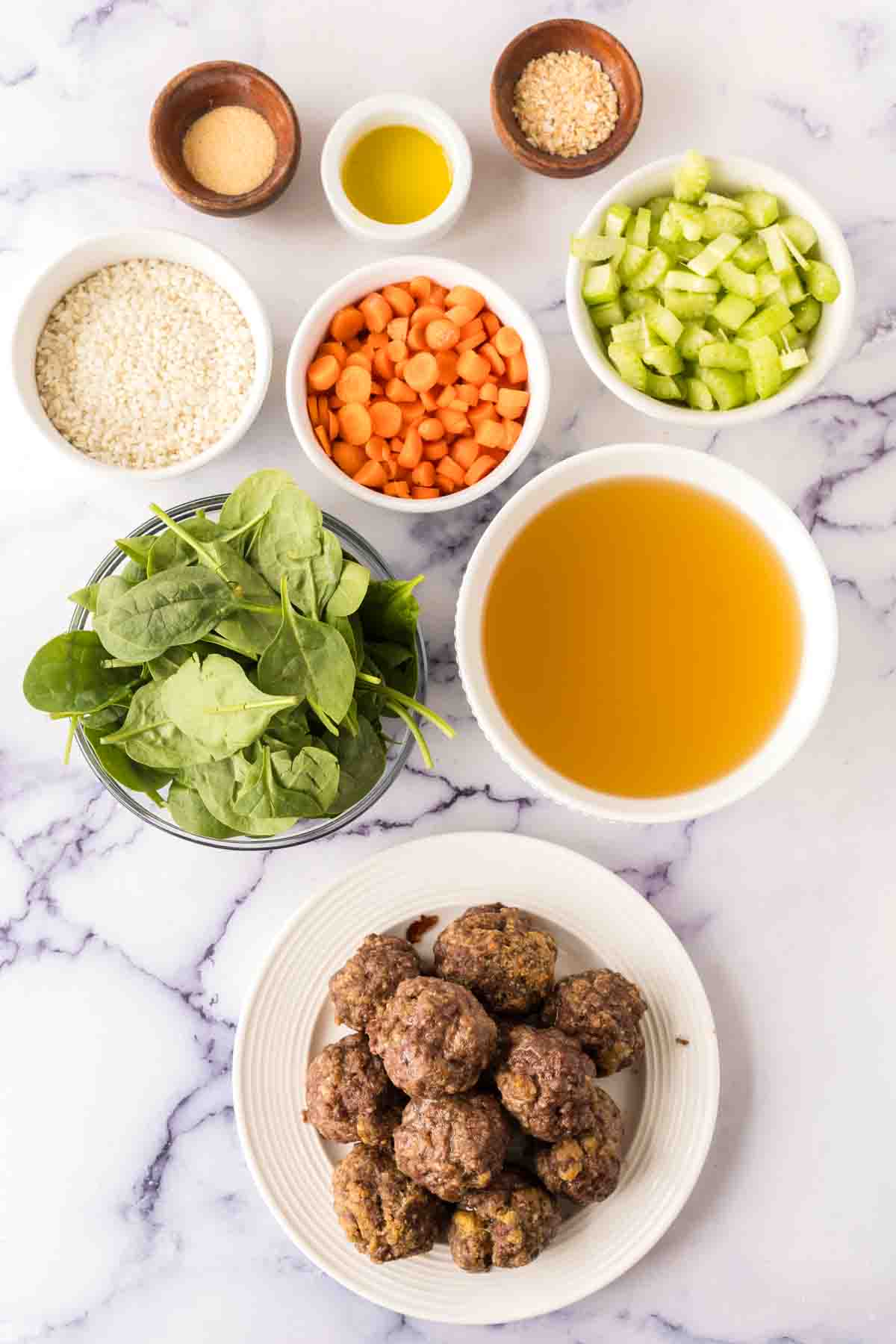 portioned dishes with raw ingredients of Italian wedding soup