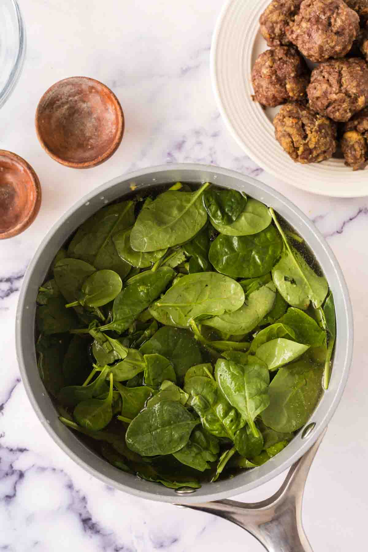 pot with raw ingredients of Italian wedding soup