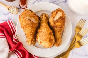 white plate with three Louisiana chicken legs.