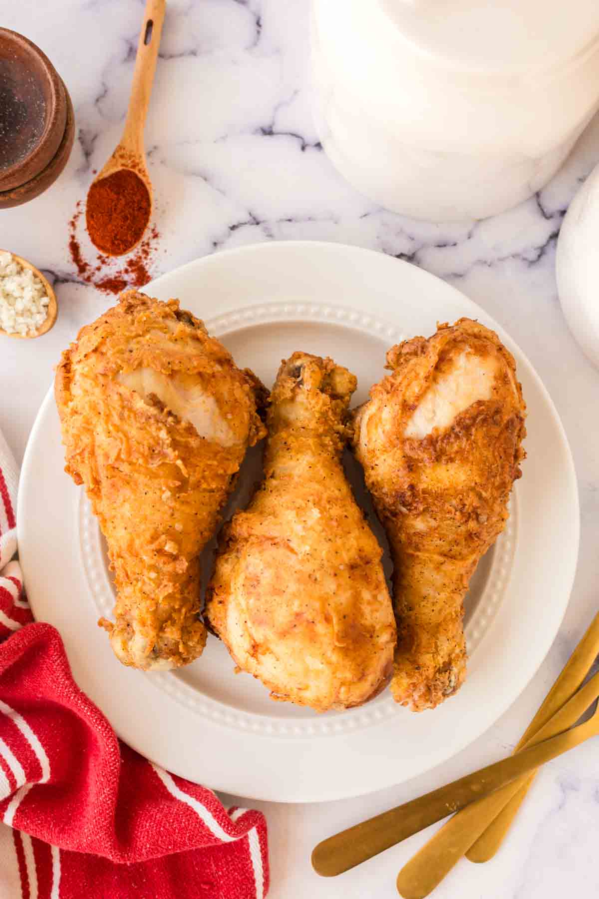 top view of a white plate with three Louisiana chicken legs