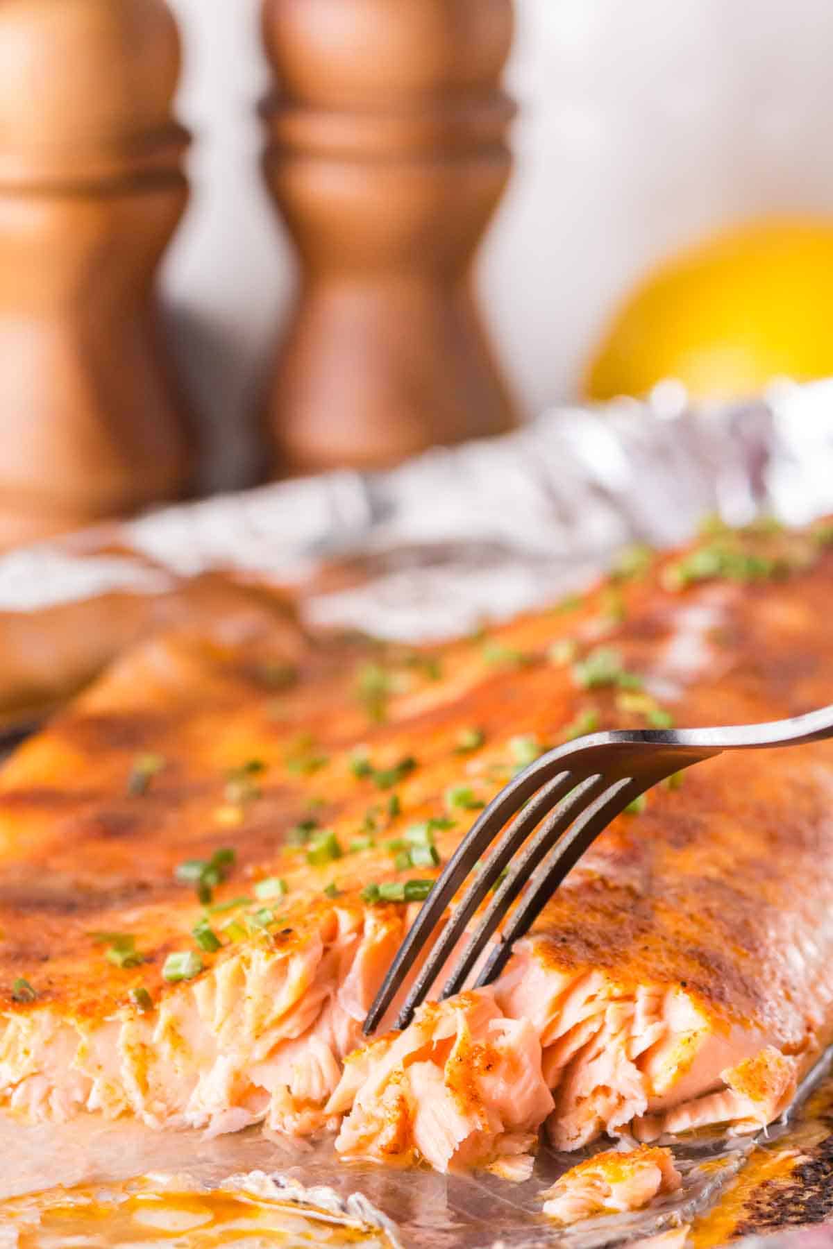 POV fork in flaky oven baked salmon