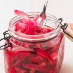 small dish with a lid filled with pickled red onions