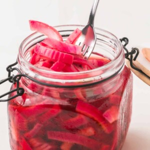 small dish with a lid filled with pickled red onions