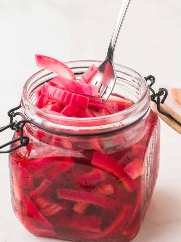 small dish with a lid filled with pickled red onions