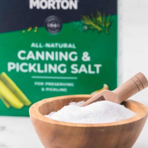 paper box of Morton's all natural canning and pickling salt with a wooden bowl of salt