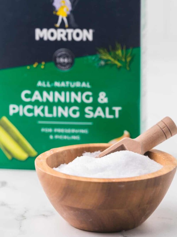 paper box of Morton's all natural canning and pickling salt with a wooden bowl of salt