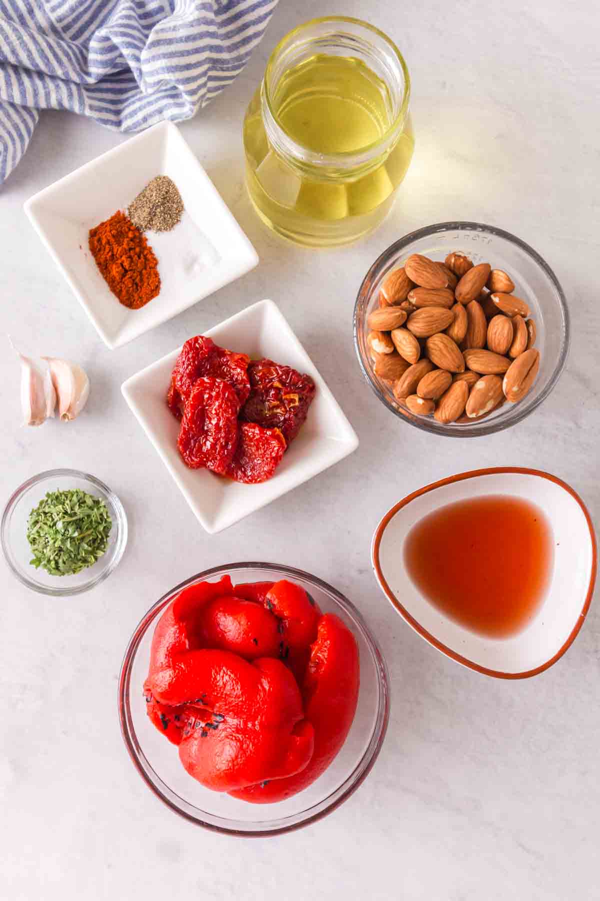 small portioned dishes with raw ingredients for romesco sauce recipe