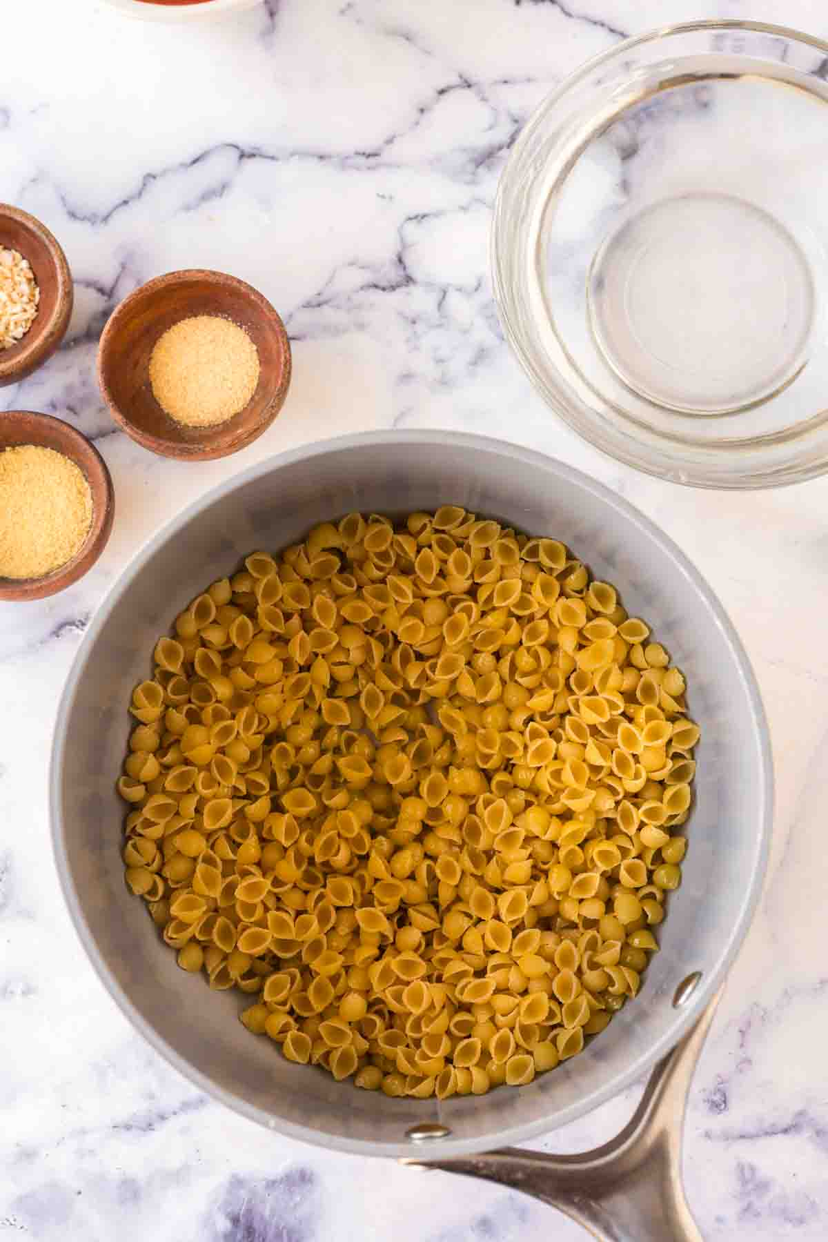 sauce pan with raw pasta for sopitas ingredients