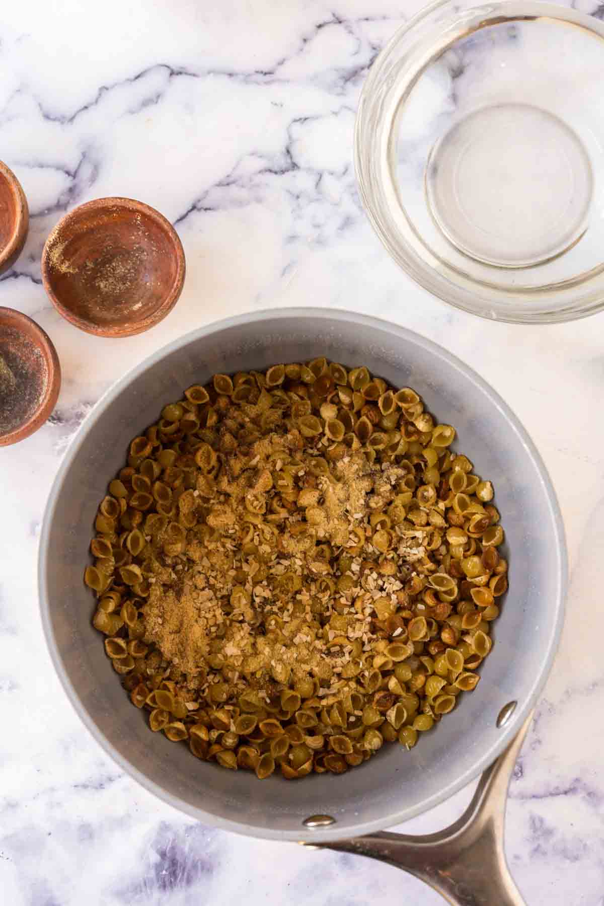 sauce pan with raw pasta for sopitas ingredients