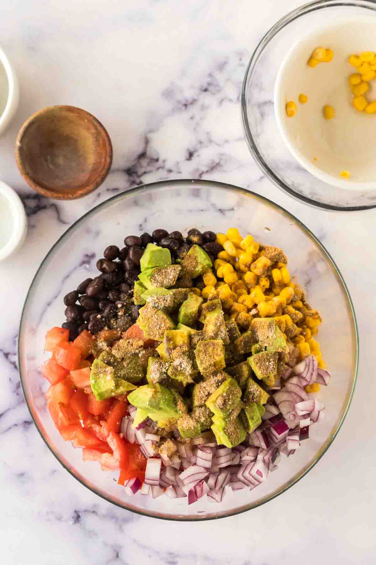 ingredients for texas caviar in a clear mixing bowl