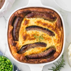 top view of a toad in a hole in a casserole dish baked and crispy dough