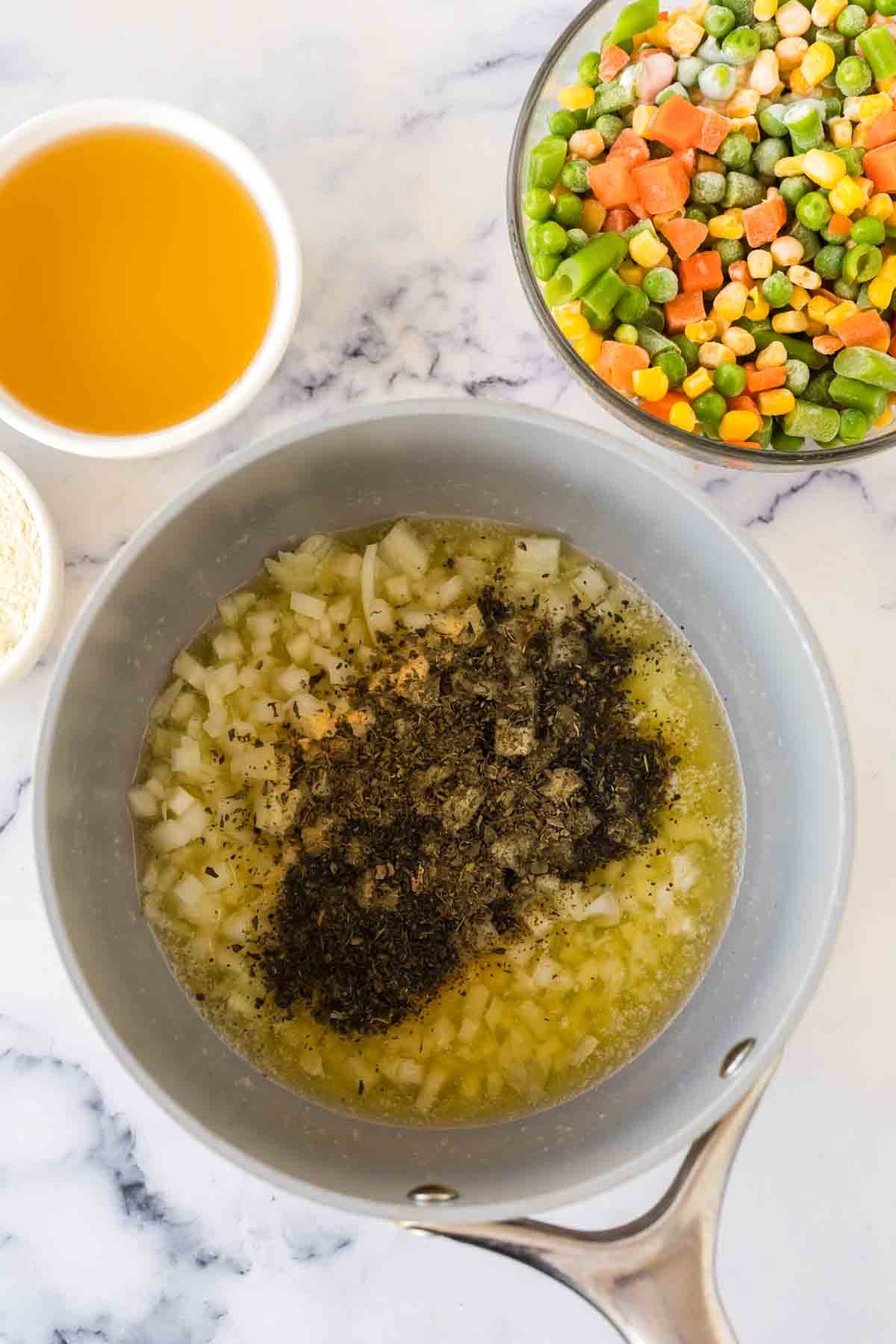 Adding ingredients to a large pot.