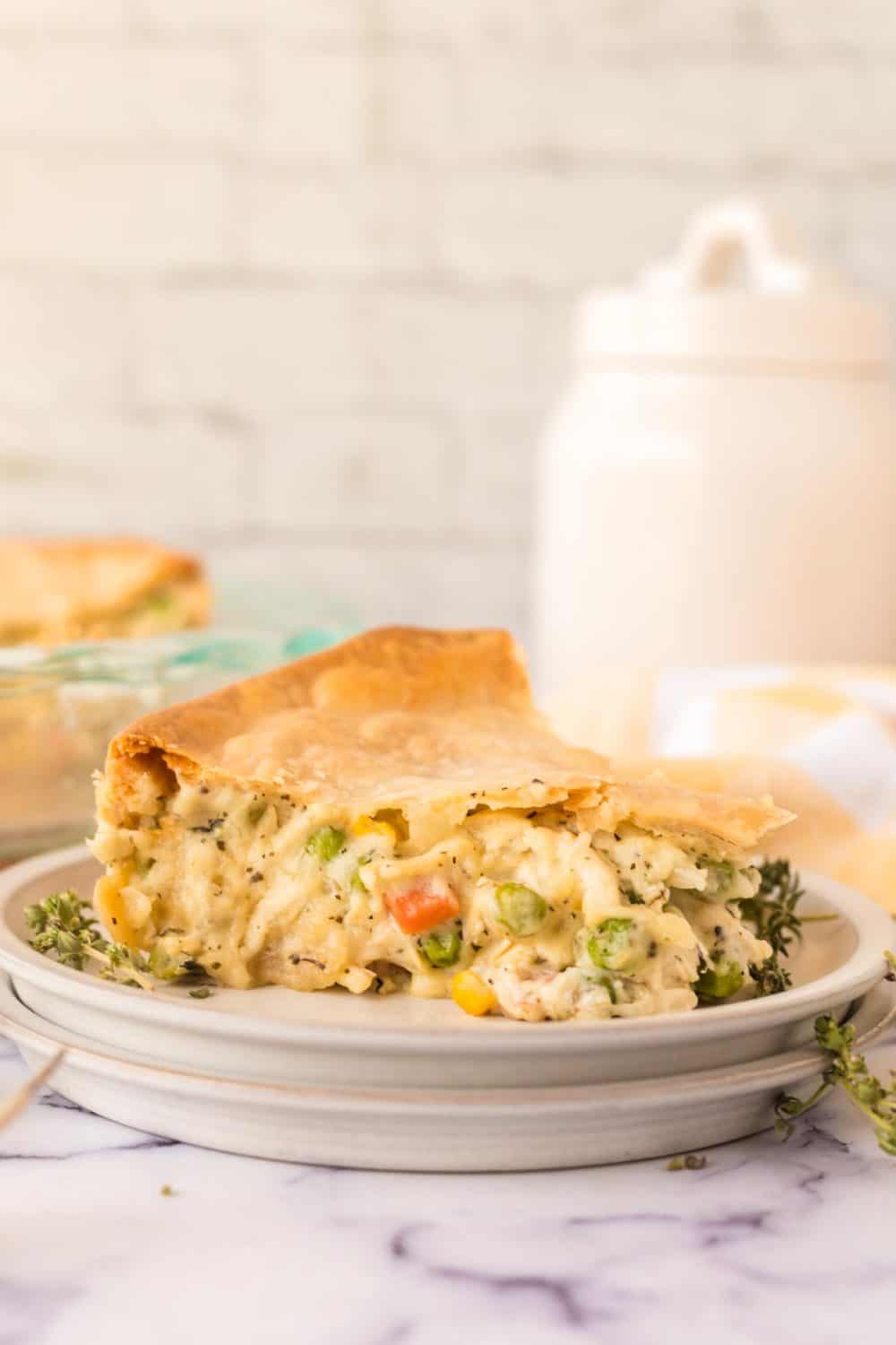 Serving of turkey pot pie on a white plate. 