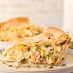 side view of one triangle slice of baked turkey pot pie on a plate