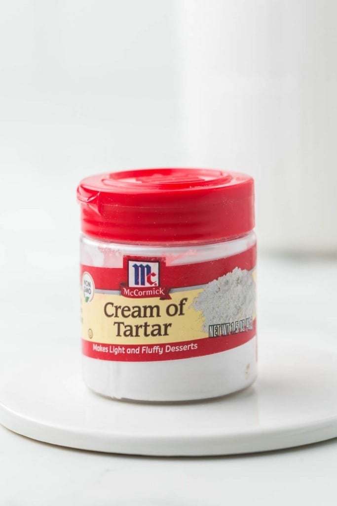small jar of McCormick cream of tartar with a red lid