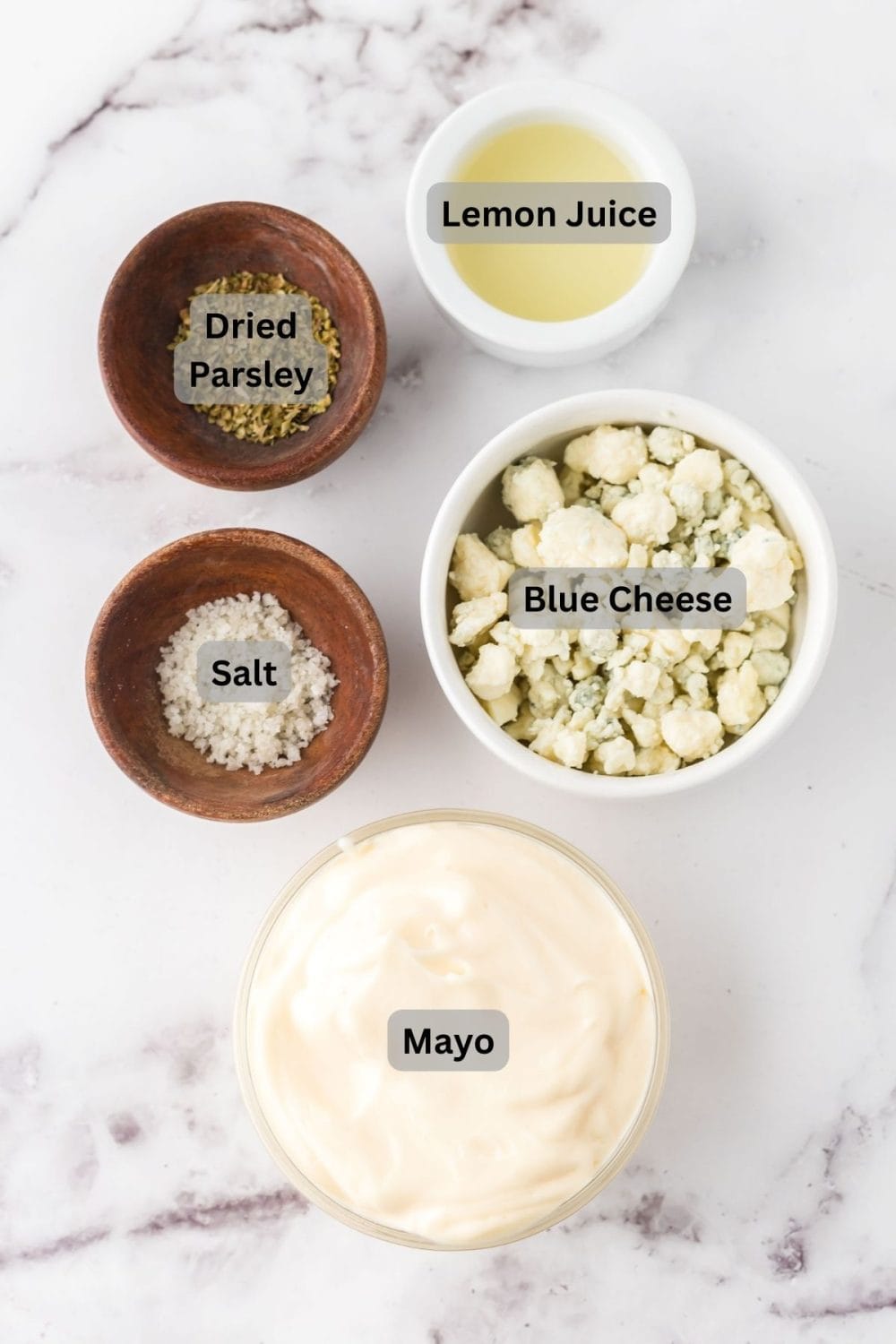 small portion dishes labeled with the raw ingredients to make blue cheese dressing