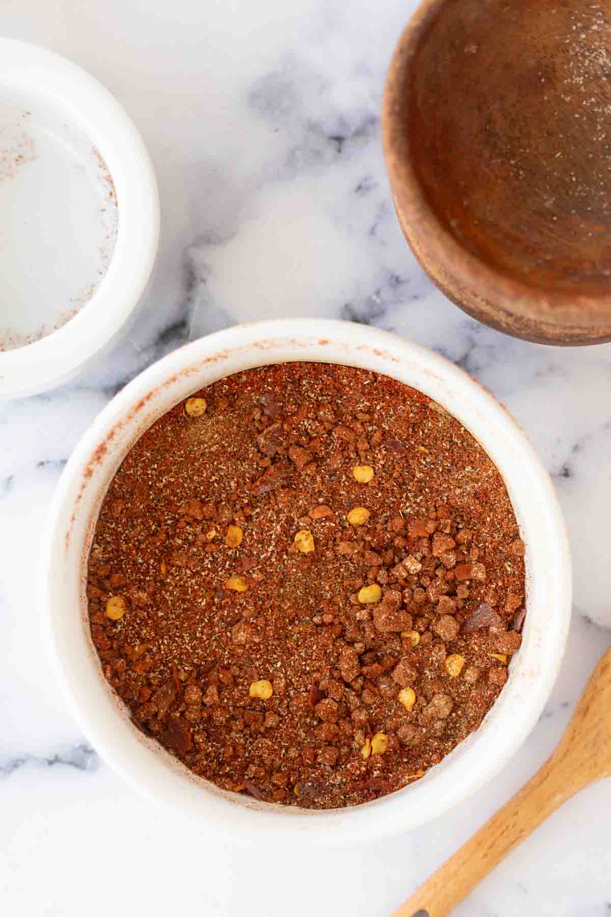 top view of a small white dish of adobo seasoning