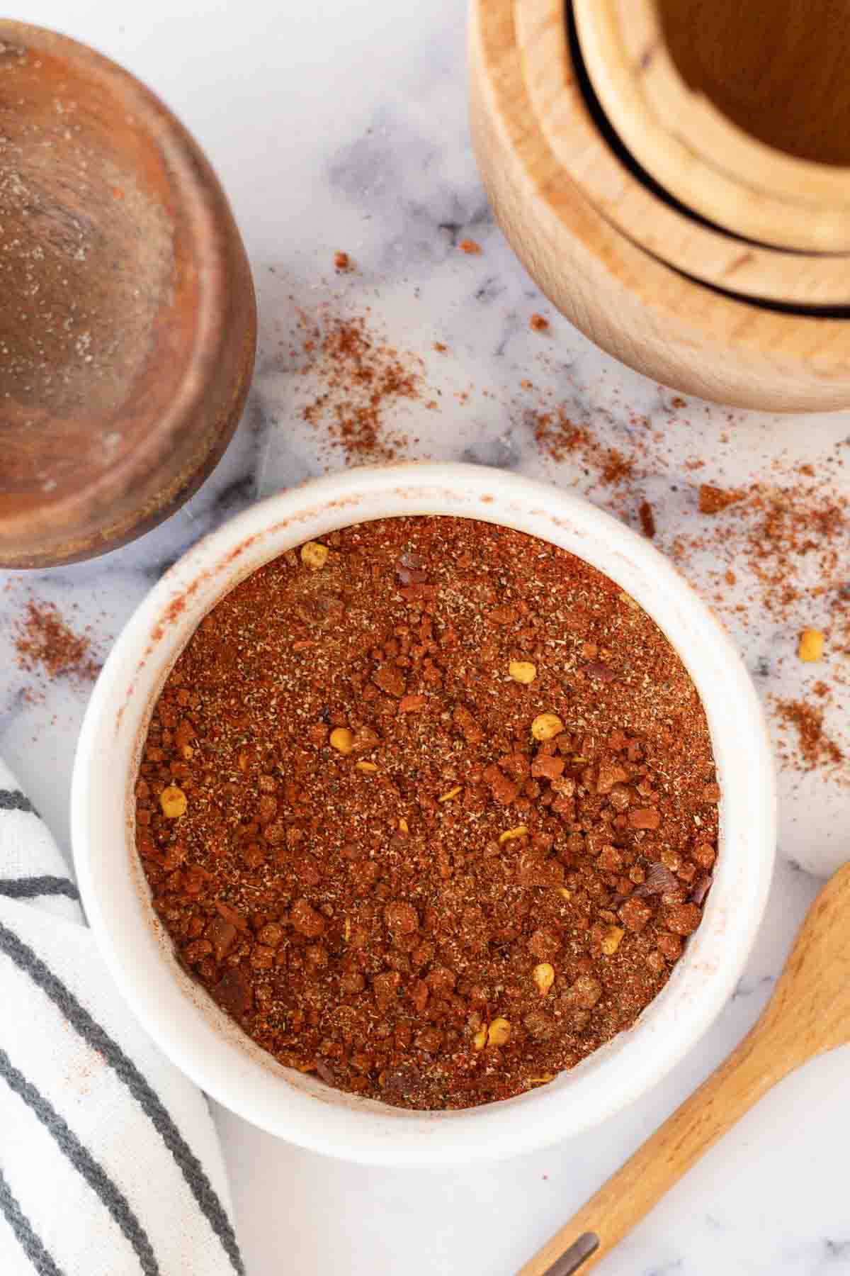 top view of a small white dish of adobo seasoning