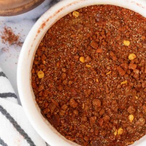 top view of a small white dish of adobo seasoning